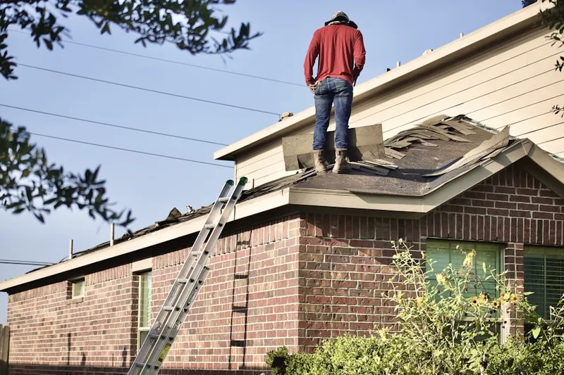 Professional roofer working on a residential roof in Falcon Shores